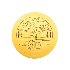 Gold sticker of Dog on stump with mountains drawing 