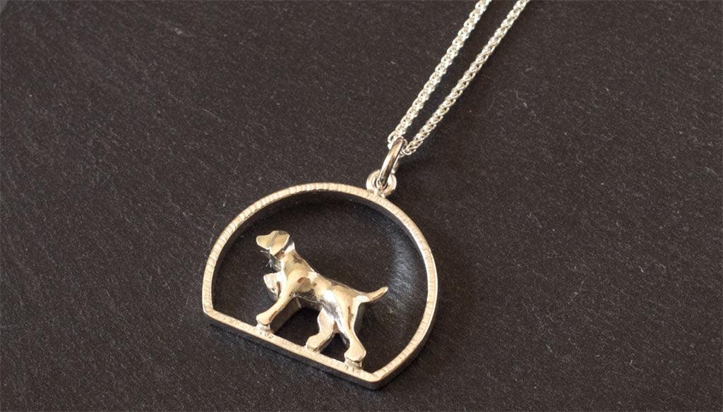 Gold pointing dog necklace encircled