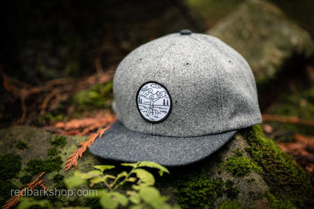 Grey melton wool hat on moss with dog details