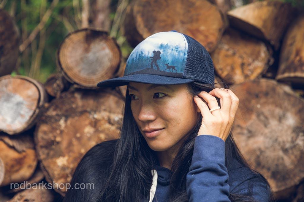 Side view of moody pnw mountain hat with backpacker and dog