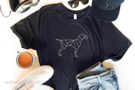 Flatlay of black Tshirt featuring geometric simple dog design