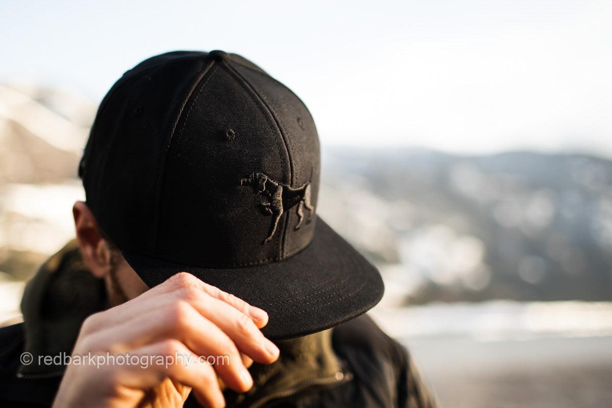 Side view of man wearing Iconic Puff embroidery Pointer dog Hat in Black