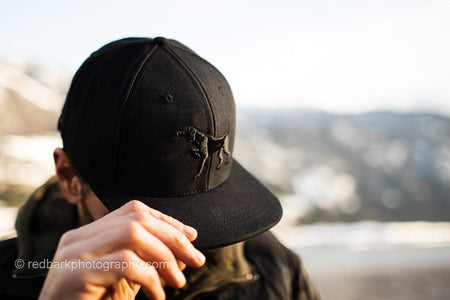 Side view of man wearing Iconic Puff embroidery Pointer dog Hat in Black